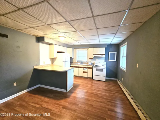 a view of kitchen with cabinets and wooden floor
