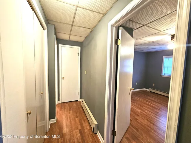 a view of hallway with wooden floor
