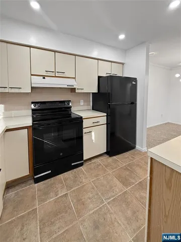 a kitchen with a cabinets and steel stainless steel appliances