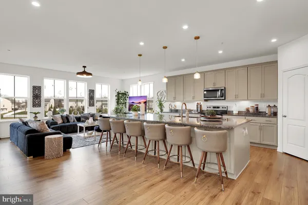 a view of a dining room kitchen with furniture wooden floor and windows