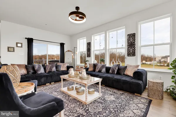 a living room with furniture and a large window