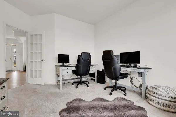a view of a livingroom with workspace and a couch