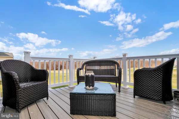 a view of living room with balcony furniture and wooden floor