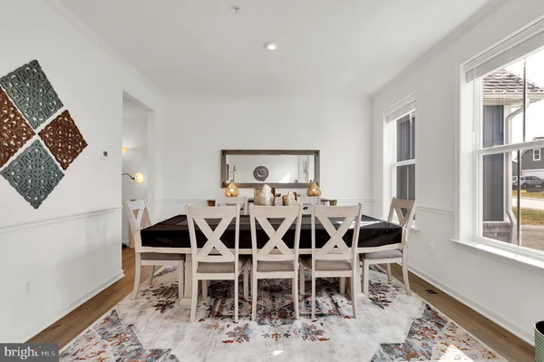 a view of a dining room with furniture and wooden floor
