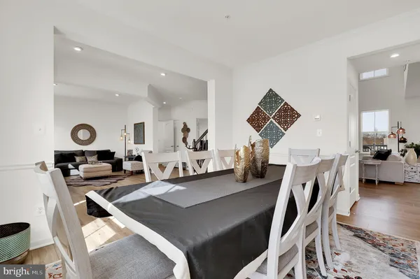 a living room with furniture a flat screen tv and a table