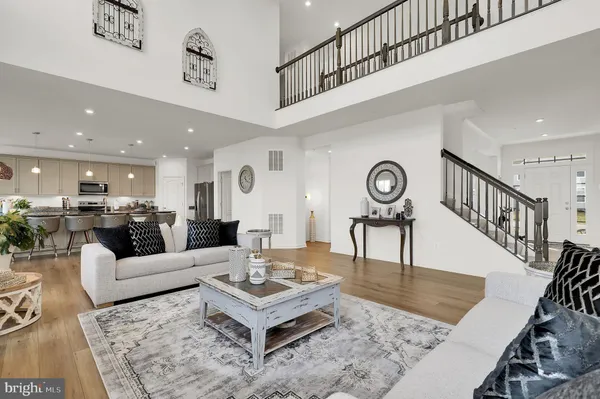 a living room with furniture rug and a table