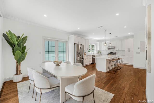 1 Kewanee Road New Rochelle, NY 10804 - Photo 7 of 36 a view of a dining room with furniture and a potted plant