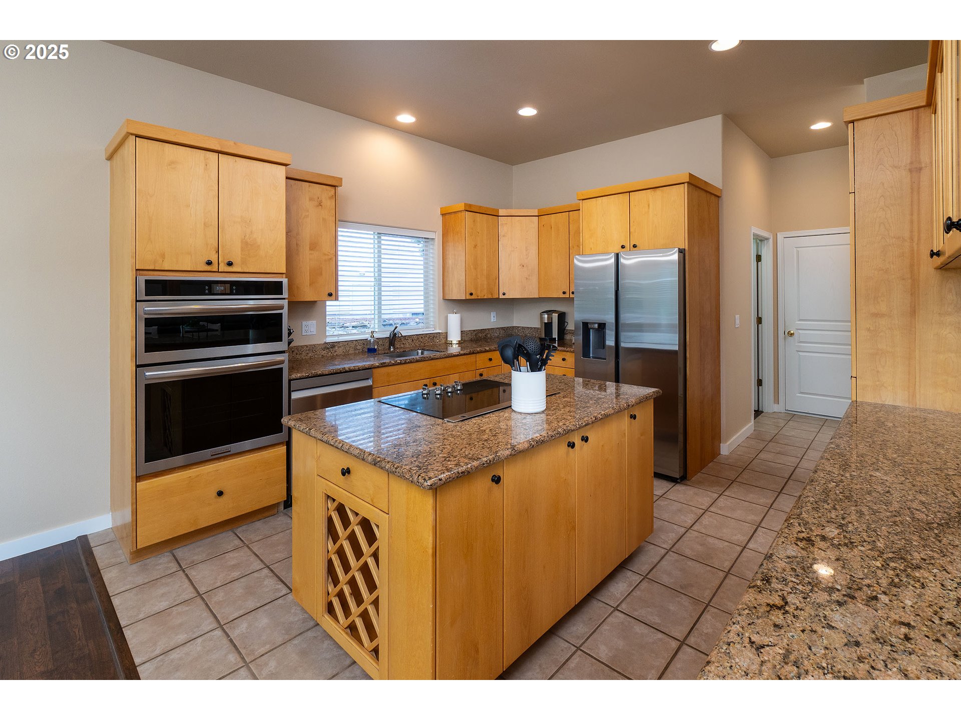 7986 Little Falls Court Redmond, OR 97756 - Photo 15 of 32 a kitchen with stainless steel appliances granite countertop a sink stove and refrigerator