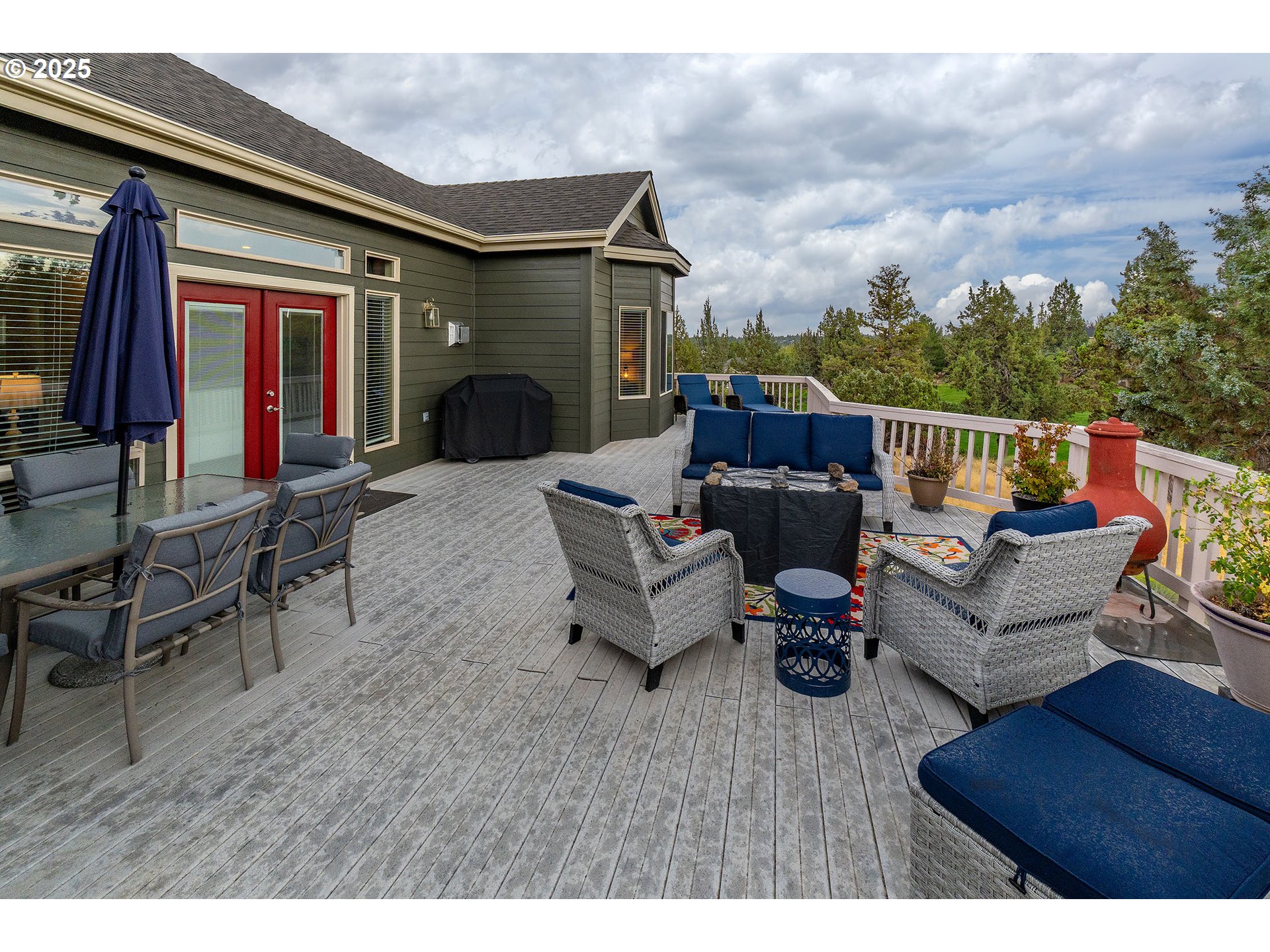 7986 Little Falls Court Redmond, OR 97756 - Photo 21 of 32 a balcony with furniture and a fireplace