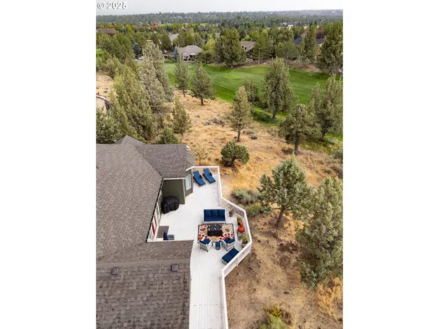 an aerial view of a house with a yard and lake view