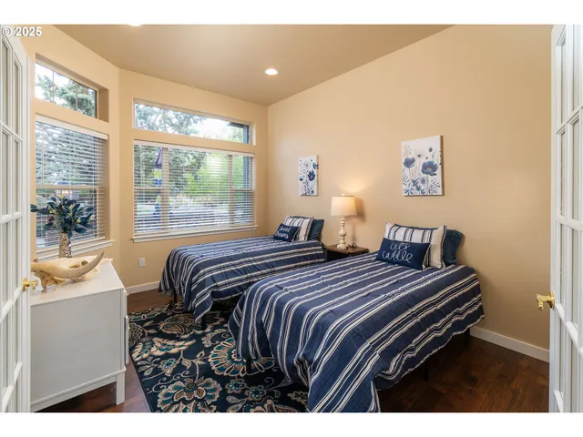 a bedroom with a bed and a large window