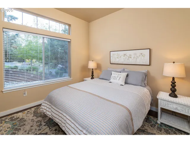 a bedroom with a bed and a large window