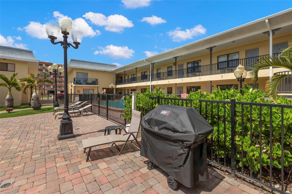 16333 Gulf Boulevard, Unit 113 Redington Beach, FL 33708 - Photo 35 of 40 a building outdoor space with patio furniture and potted plants