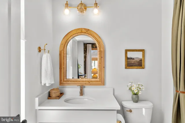 a living room with fireplace furniture and a large window