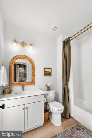 a living room with stainless steel appliances furniture a dining table and a kitchen view
