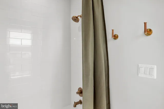 a living room with furniture a flat screen tv and a large window