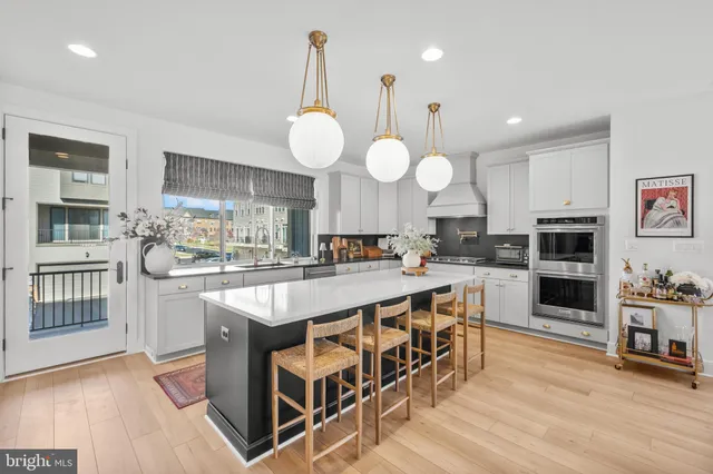 a living room with furniture a flat screen tv and a large window