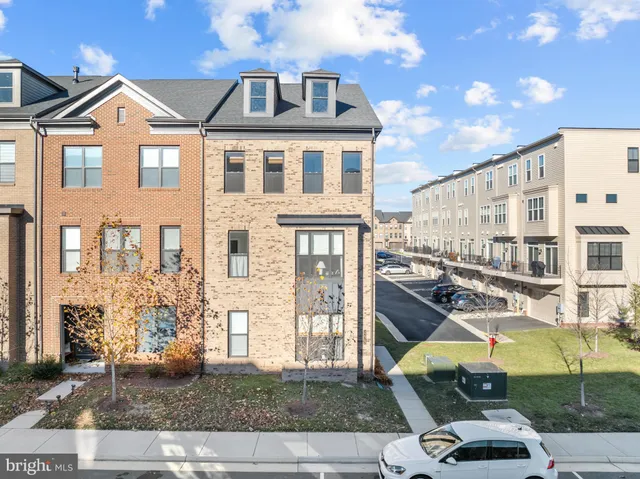 a front view of a residential apartment building with a yard