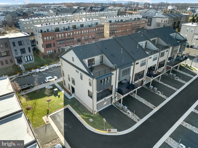 an aerial view of residential houses with yard
