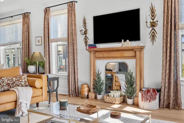 a living room with furniture and a flat screen tv with wooden floor