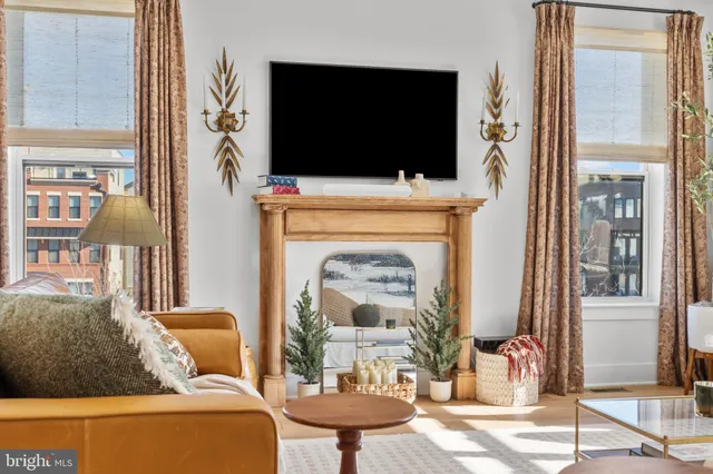 a view of a swimming pool with a patio and city view