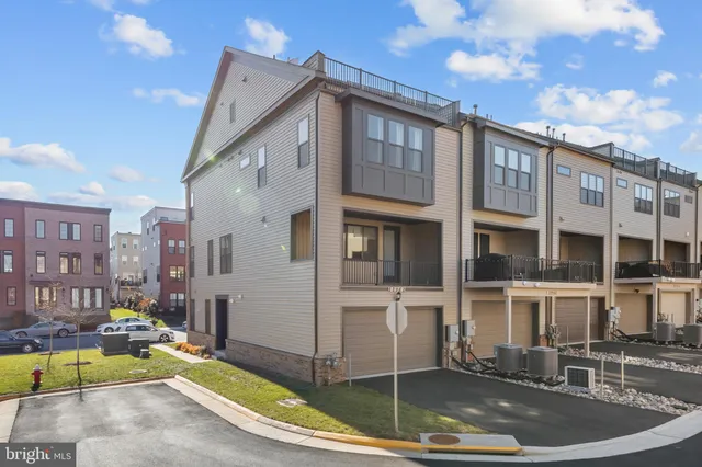 a bed sitting in a spacious bedroom next to a window