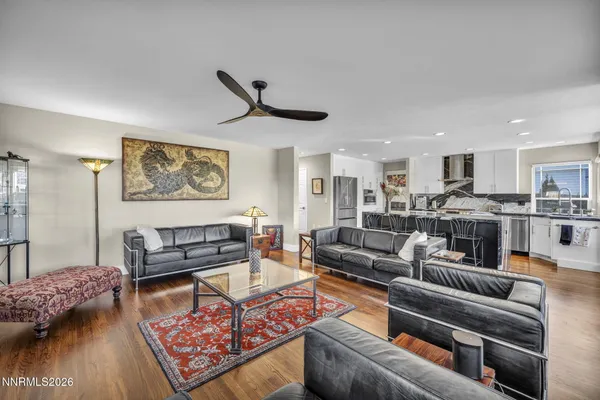 a living room with furniture and kitchen view