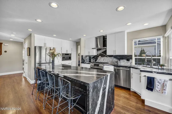 a kitchen with stainless steel appliances granite countertop a stove and a microwave