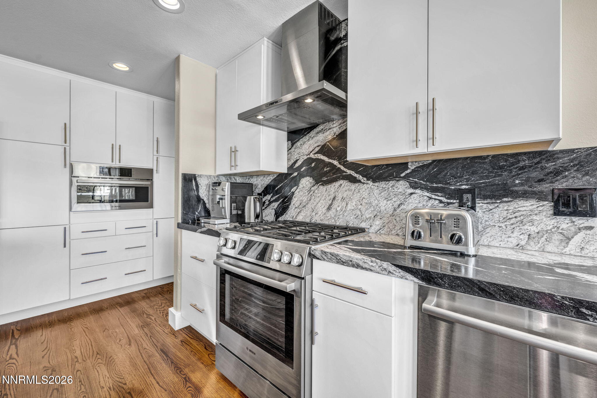 2296 Oak Ridge Drive Carson City, NV 89703 - Photo 17 of 72 a kitchen with stainless steel appliances granite countertop a stove and a microwave