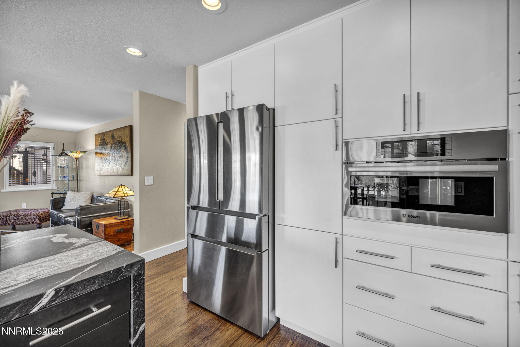 2296 Oak Ridge Drive Carson City, NV 89703 - Photo 19 of 72 a kitchen with stainless steel appliances a stove a refrigerator and cabinets