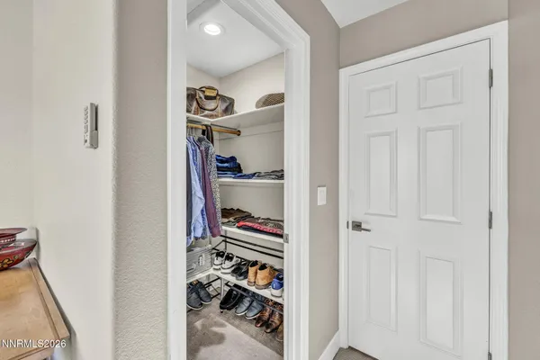 a bathroom with a double vanity sink a toilet and shower