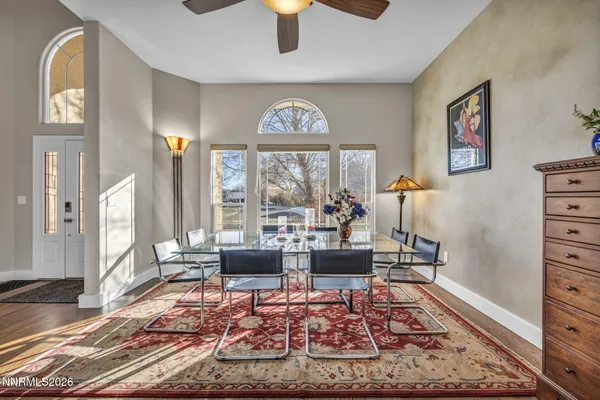 a living room with furniture and a floor to ceiling window
