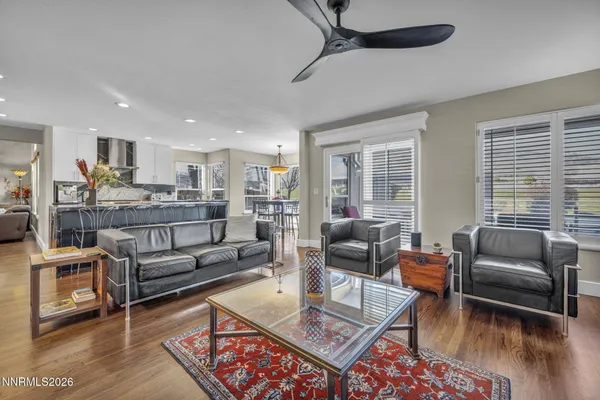 a living room with furniture and a wooden floor