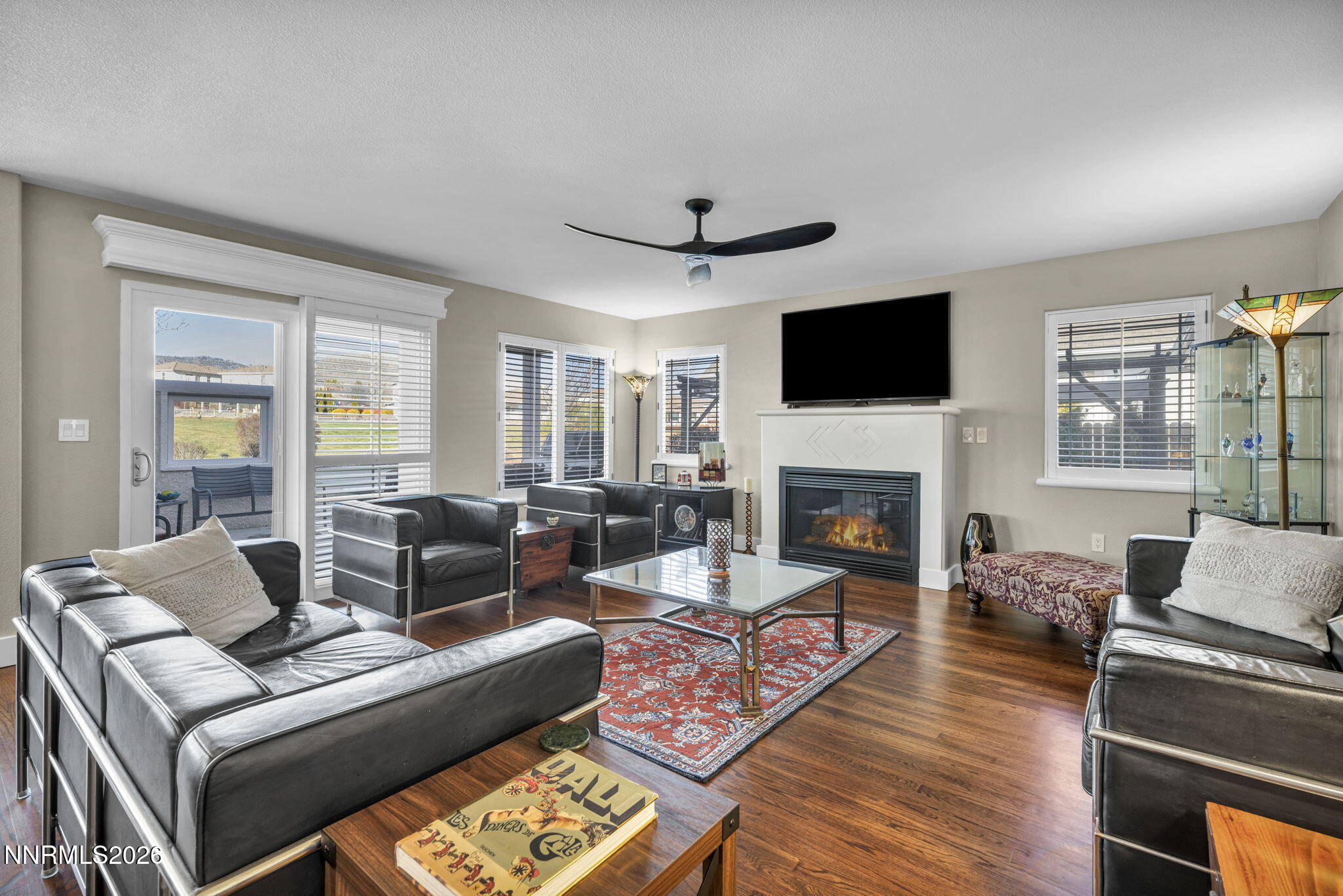 2296 Oak Ridge Drive Carson City, NV 89703 - Photo 10 of 72 a living room with furniture a flat screen tv and a fireplace
