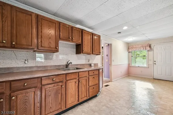 a kitchen with sink cabinets and window