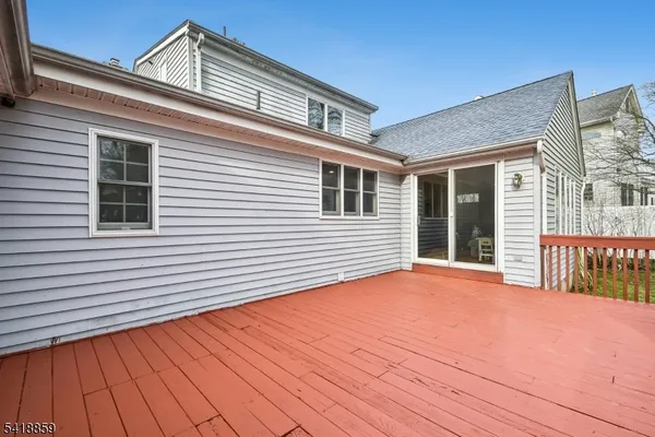 a view of a house with deck and wooden floor
