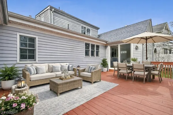 a view of a patio with couches table and chairs and potted plants