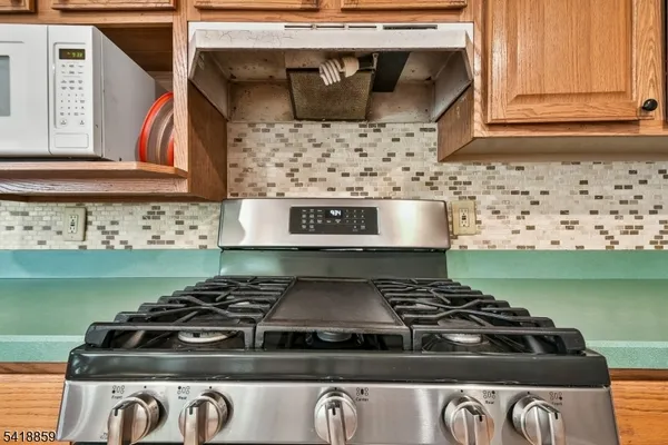 a stove top oven sitting inside of a kitchen