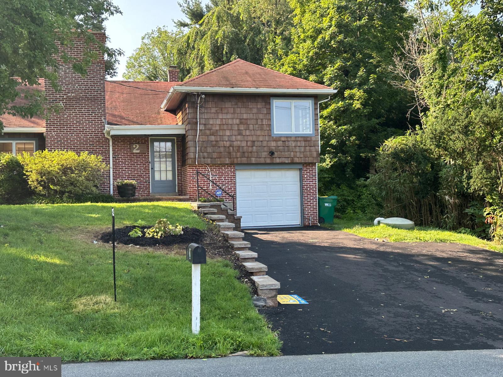 2 Snuff Mill Road Wilmington, DE 19807 - Photo 3 of 16 Charming brick home with lush greenery.