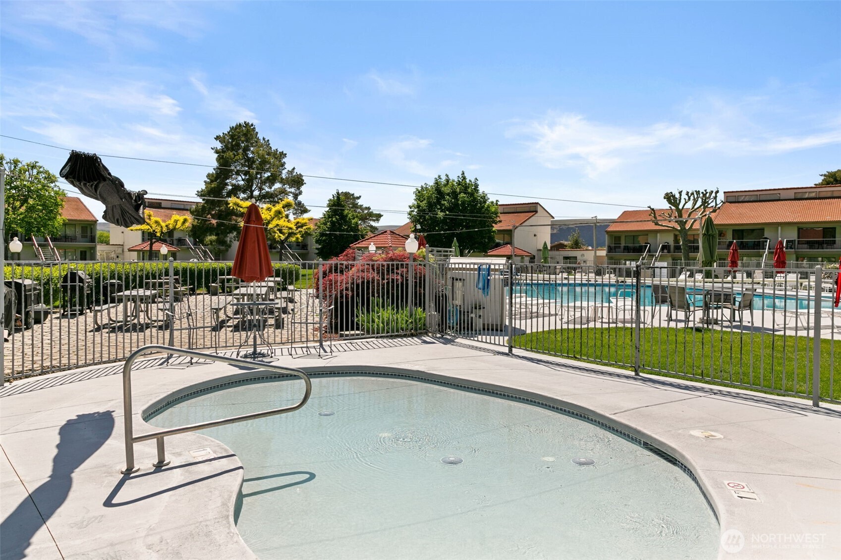 8903 Crescent Bar Road Northwest, Unit 101 Quincy, WA 98848 - Photo 26 of 40 a view of a swimming pool with a patio and a garden