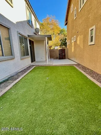 a view of a patio with couches plants and floor to ceiling window