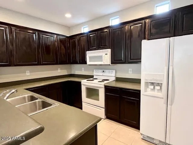 a kitchen with a cabinets and white appliances