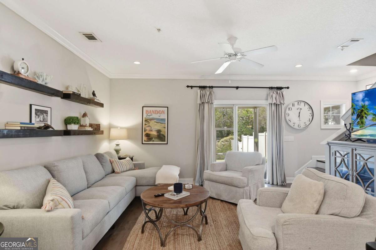 203 Mariners Circle St. Simons, GA 31522 - Photo 11 of 32 a living room with furniture and a large window