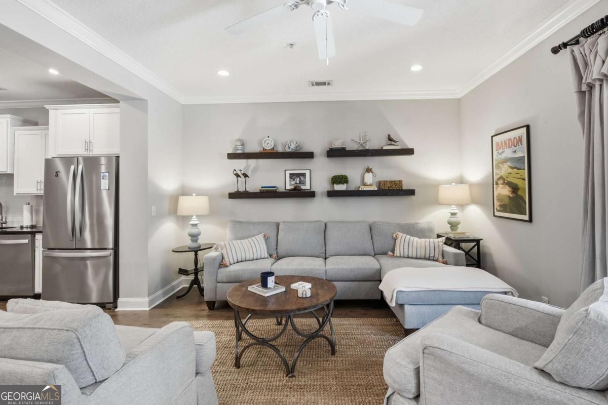 203 Mariners Circle St. Simons, GA 31522 - Photo 12 of 32 a living room with furniture and a refrigerator