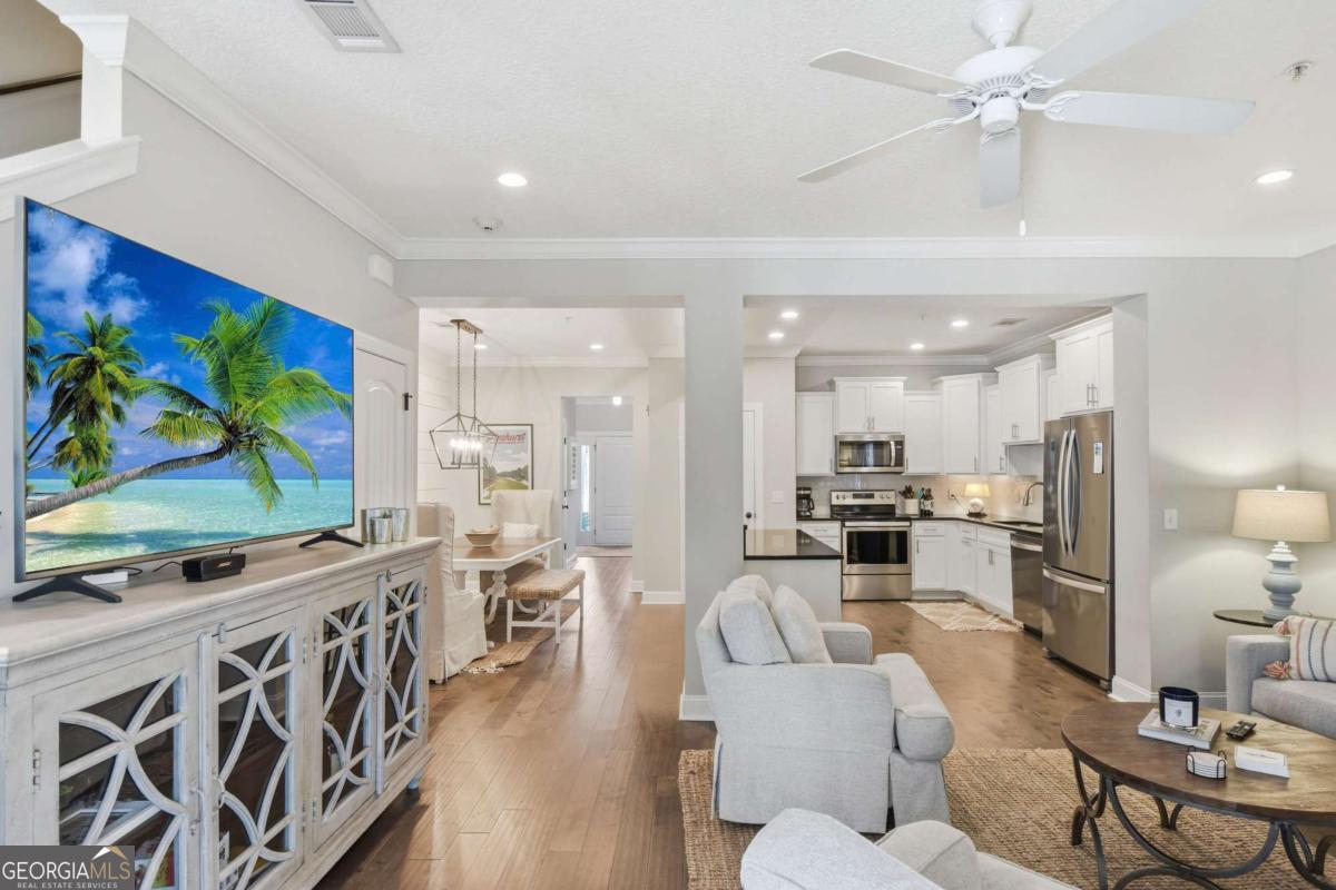 203 Mariners Circle St. Simons, GA 31522 - Photo 18 of 32 a living room with stainless steel appliances furniture a chandelier a kitchen view and a kitchen view