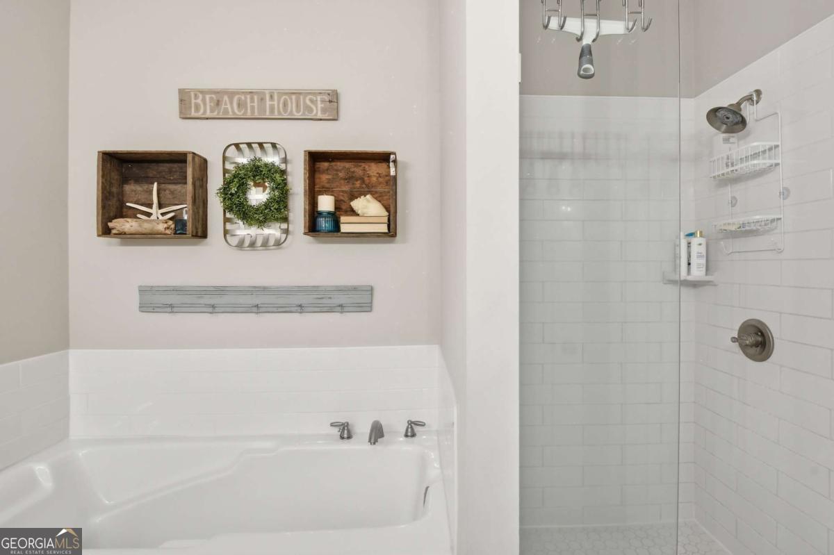 203 Mariners Circle St. Simons, GA 31522 - Photo 24 of 32 a bathroom with a bathtub and shower