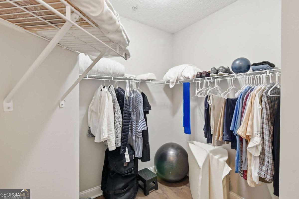 203 Mariners Circle St. Simons, GA 31522 - Photo 26 of 32 a view of walk in closet with clothes and shoes