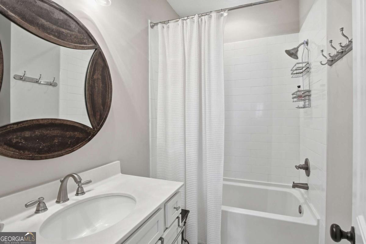 203 Mariners Circle St. Simons, GA 31522 - Photo 28 of 32 a bathroom with a sink a toilet and a mirror