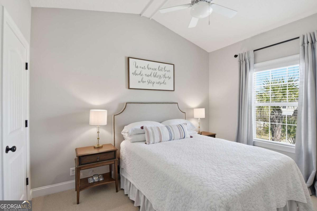 203 Mariners Circle St. Simons, GA 31522 - Photo 29 of 32 a bedroom with a bed and a window