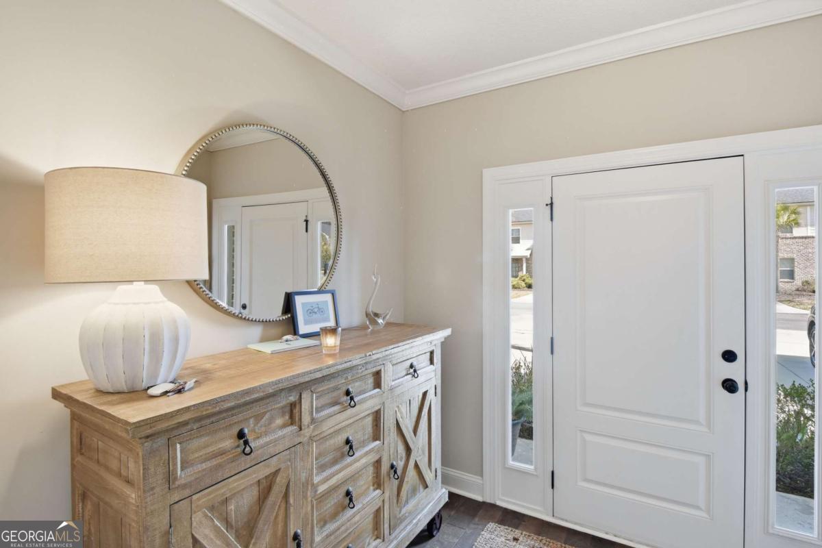 203 Mariners Circle St. Simons, GA 31522 - Photo 3 of 32 a bathroom with a sink a mirror and vanity